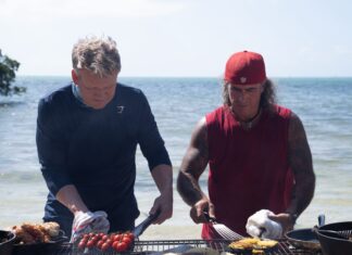 a couple of men cooking on top of a grill