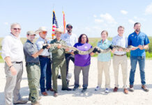 a group of people holding up a snake