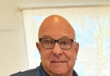 a man in a blue shirt and glasses