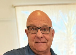 a man in a blue shirt and glasses