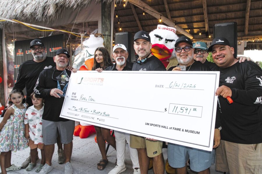 a group of people standing around a giant check