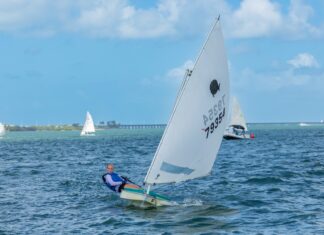 a man riding a sailboat on top of a body of water