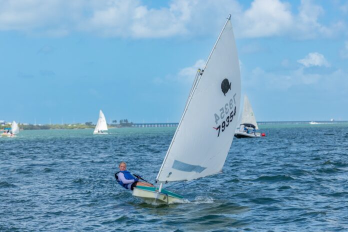 a man riding a sailboat on top of a body of water