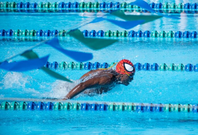 a man swimming in a swimming pool