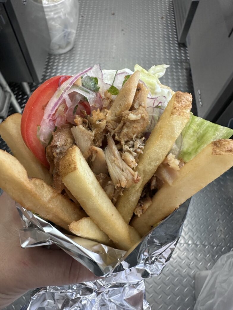 a person holding a sandwich in their hand