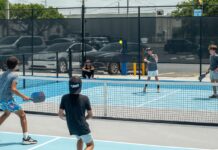a group of young men playing a game of tennis