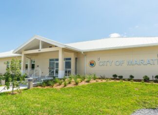 the city of marathon sign in front of a building