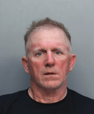 a mug shot of a man in a black shirt