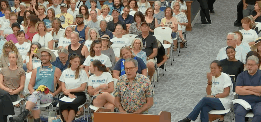 a large group of people are sitting in chairs