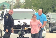 a woman standing next to a police officer next to a motorcycle