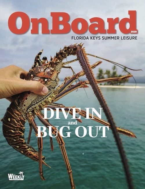 a person holding a large lobster on the cover of a magazine