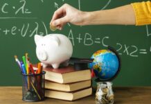 a person putting a coin into a piggy bank