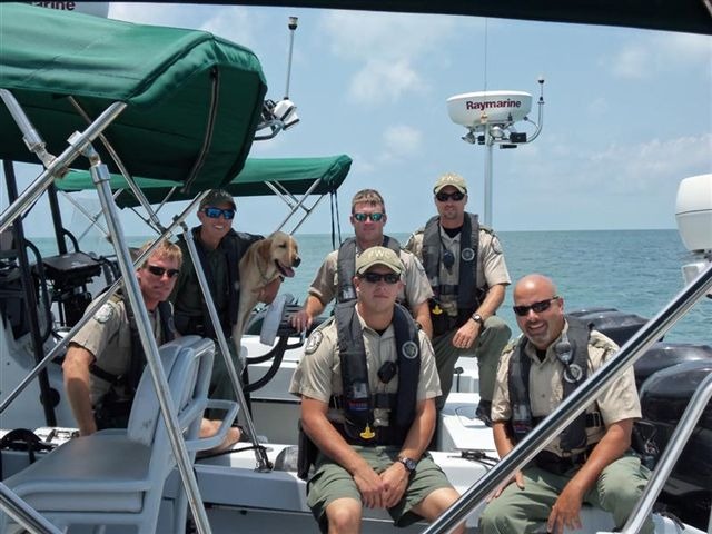 a group of men sitting on top of a boat