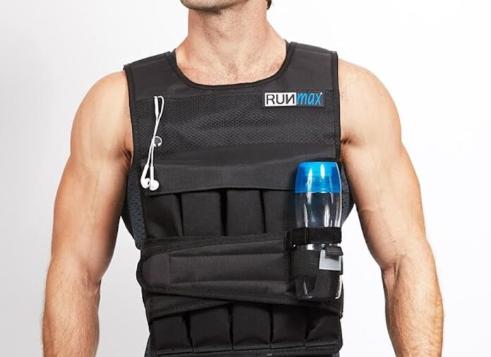 a man in a black vest holding a water bottle