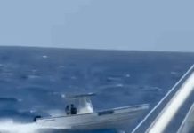 a small boat in the middle of the ocean