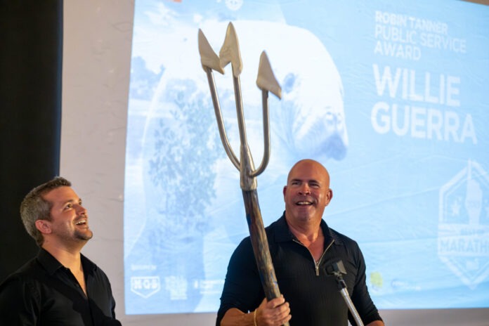 two men are standing in front of a screen