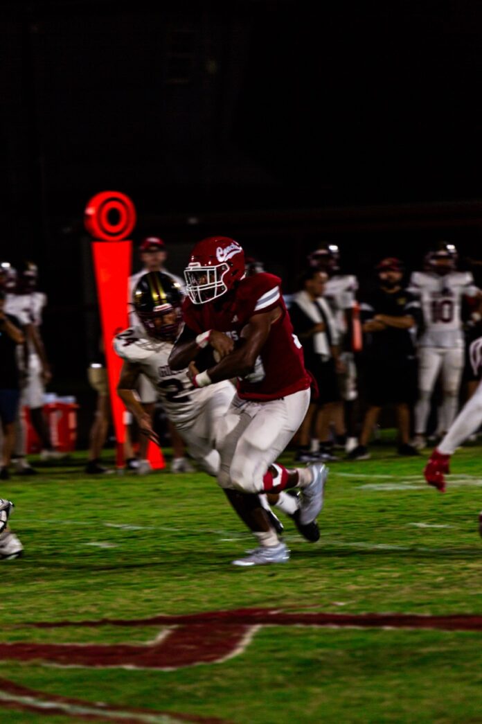 a football player running with the ball during a game