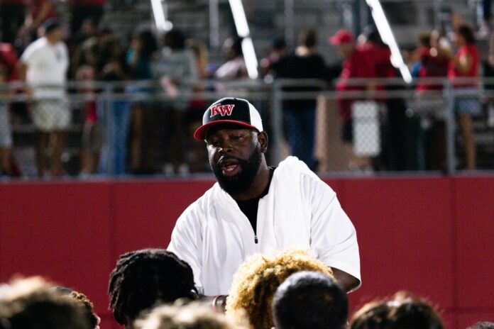 15 Large a man sitting in front of a crowd of people