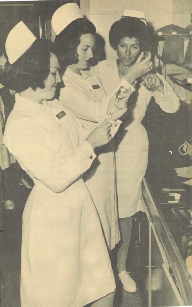 a black and white photo of a group of nurses