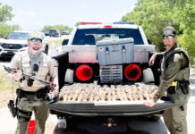 a couple of men standing next to a truck