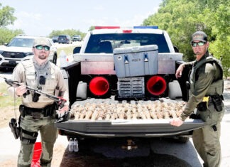 a couple of men standing next to a truck