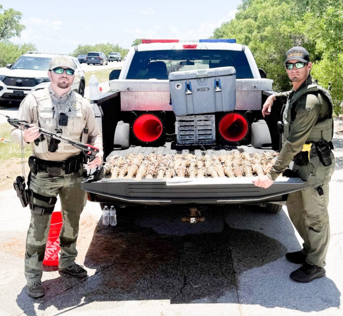 Lobster catch arrest a couple of men standing next to a truck