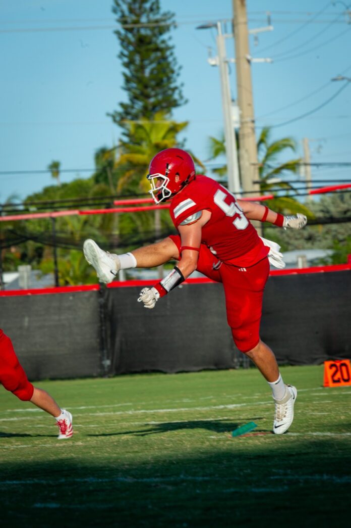 a football player running with the ball in his hand