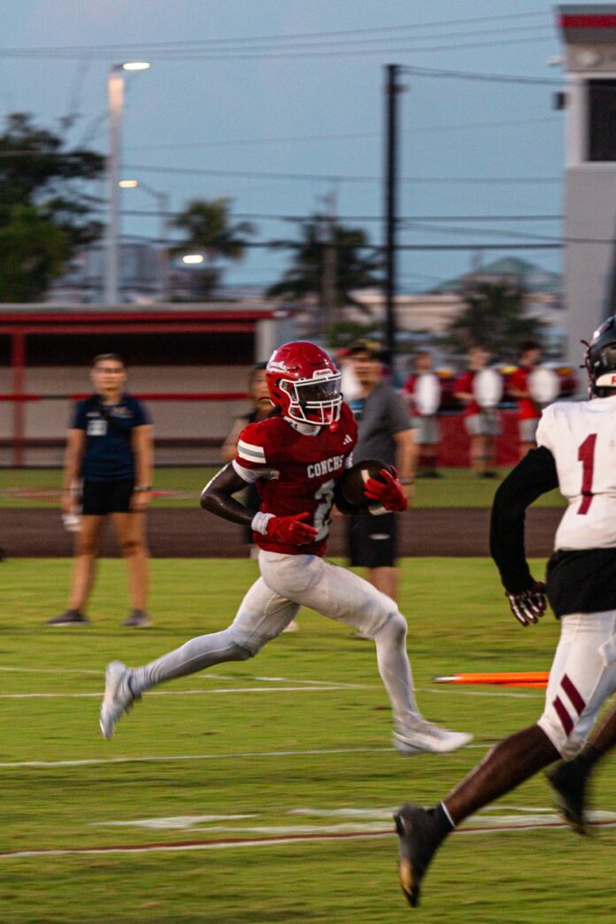 a football player running with the ball during a game