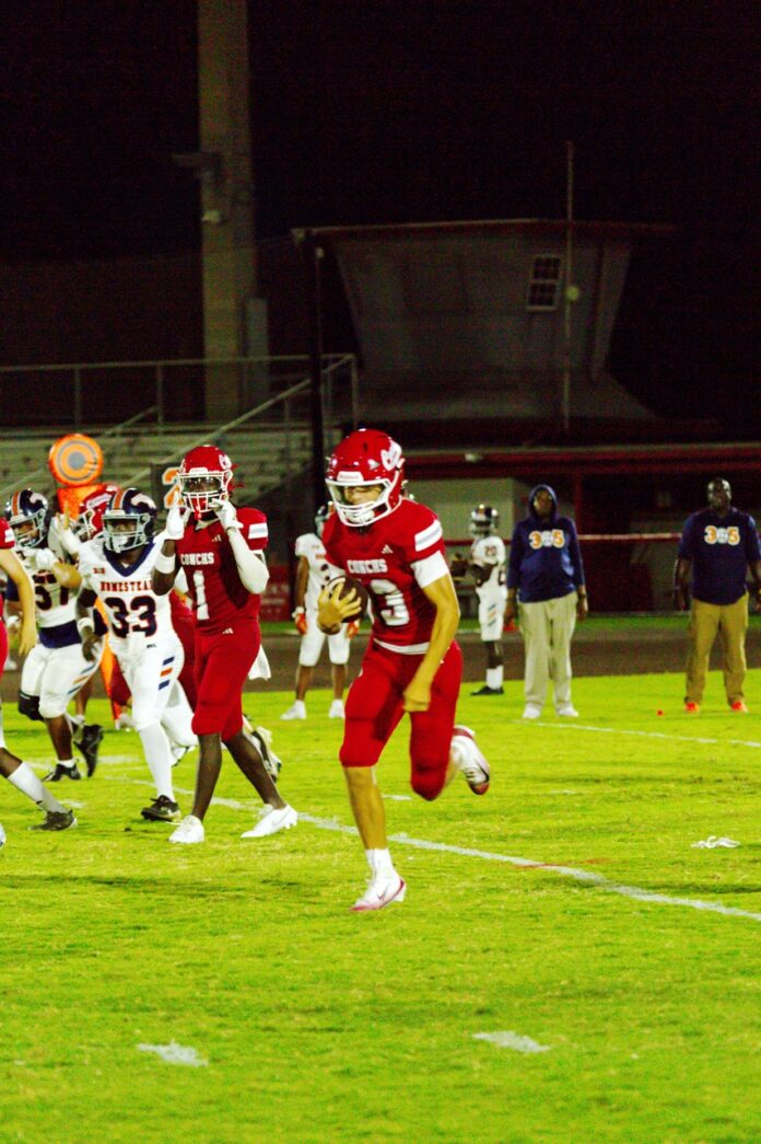 a football game with a player running for the ball
