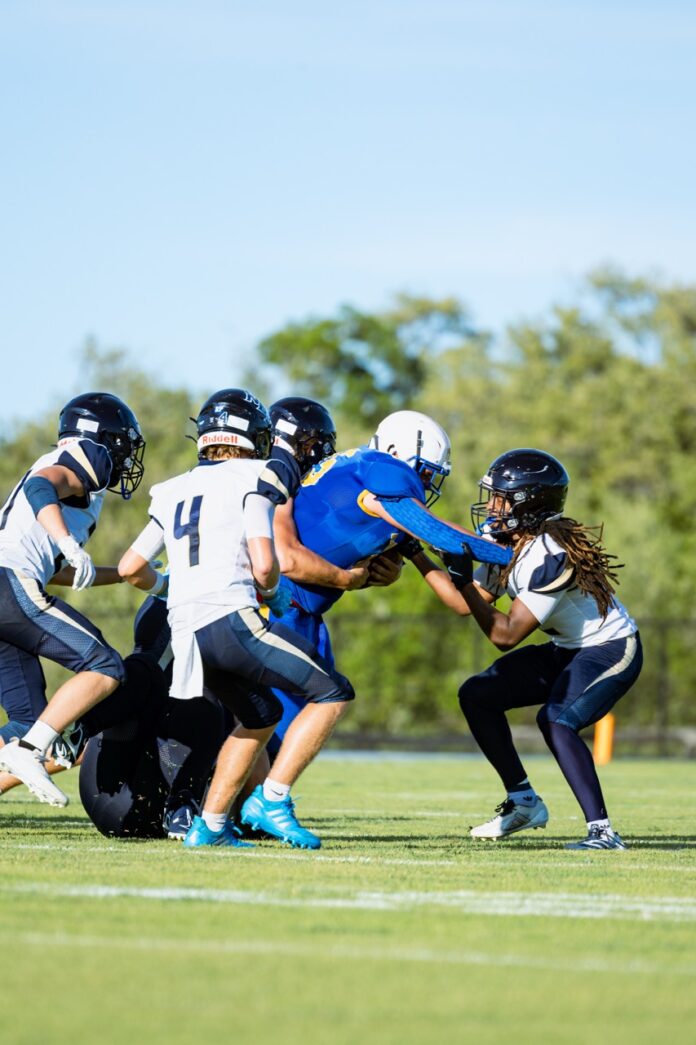 a group of young people playing a game of football