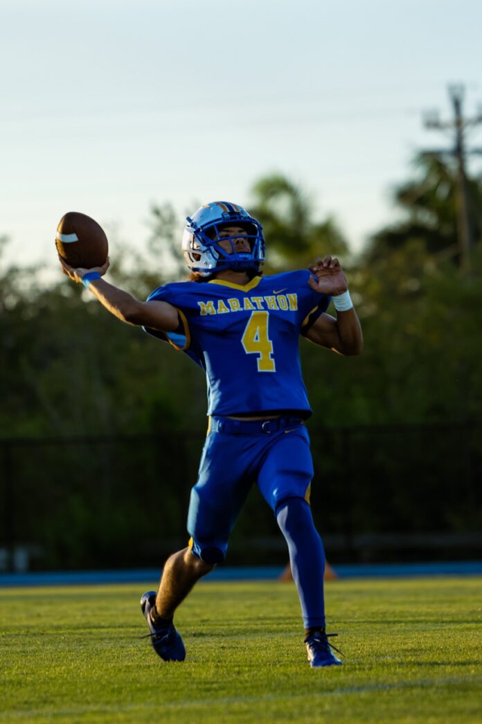 a football player throwing a ball on a field