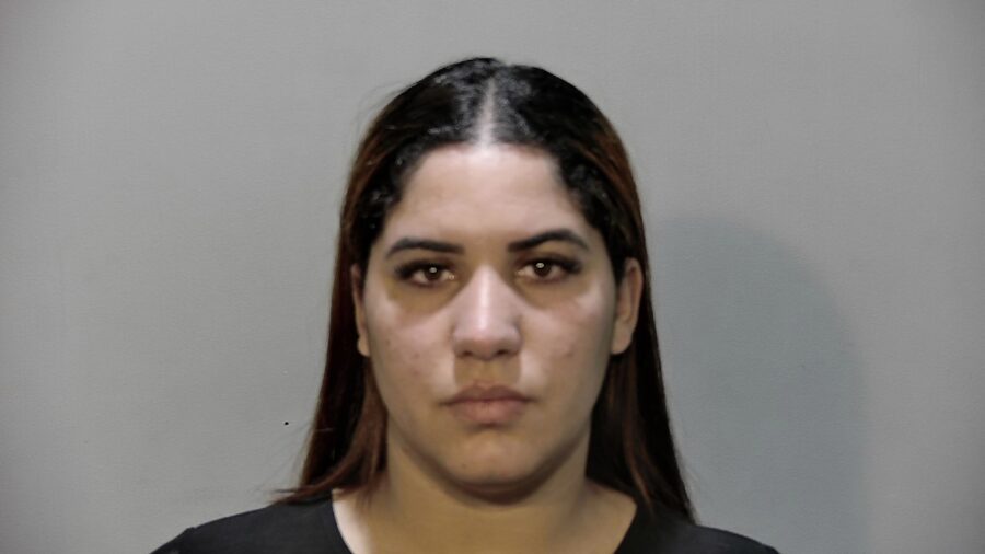 a mug shot of a woman in a black shirt