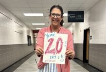 a woman holding a sign that says 20 year old