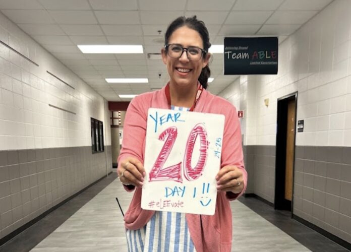 Screenshot a woman holding a sign that says 20 year old