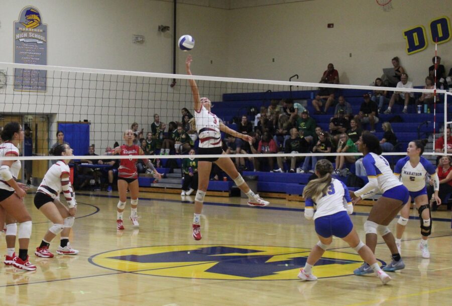 a group of young women playing a game of volleyball