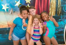 a group of young girls standing next to each other