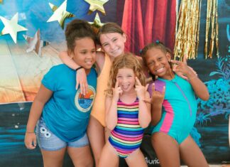 a group of young girls standing next to each other