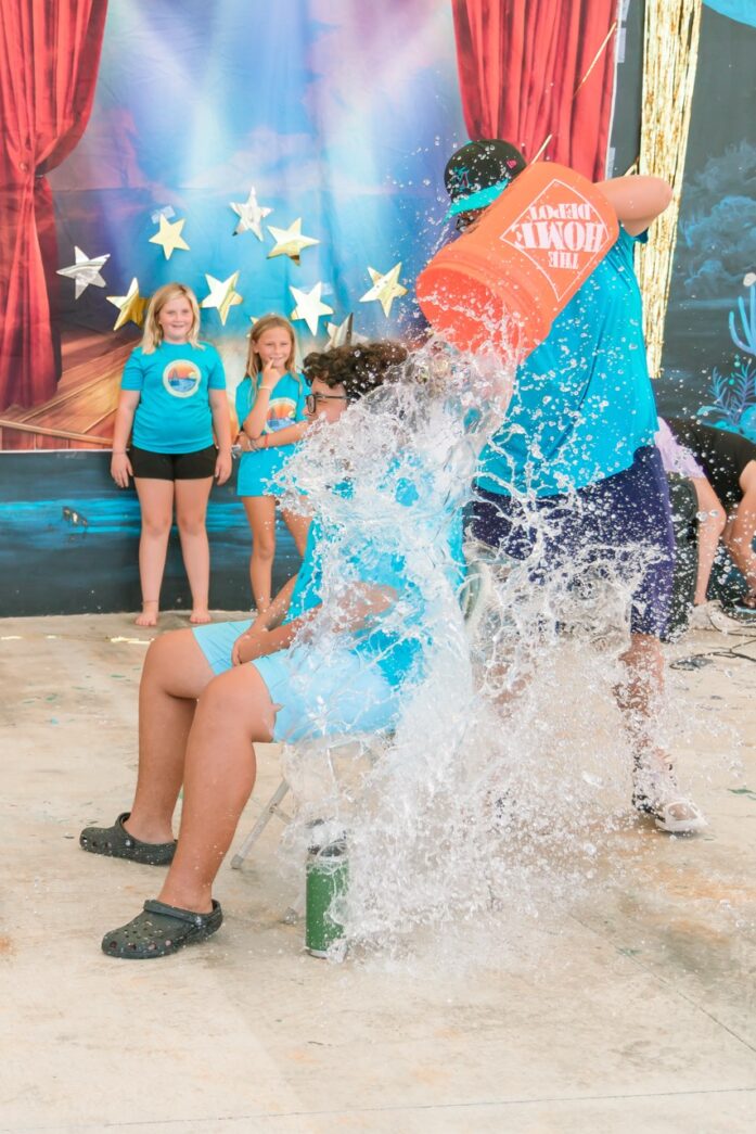 a group of children playing in a water park