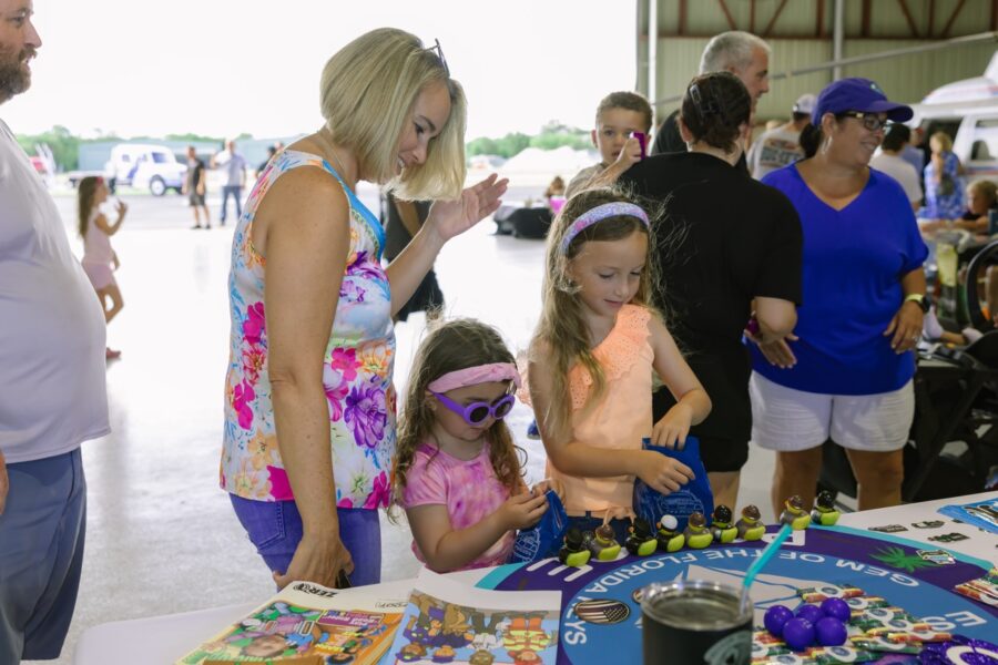 a group of people standing around a table