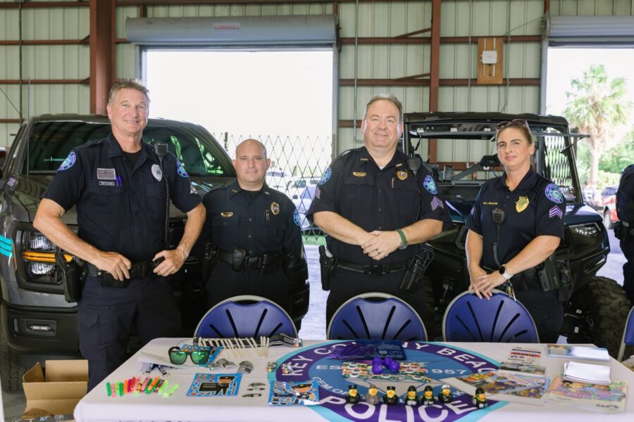 a group of police officers standing in front of a cake