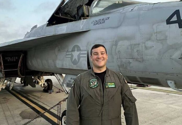 Caleb Hiller fighter pilot a man standing in front of a fighter jet