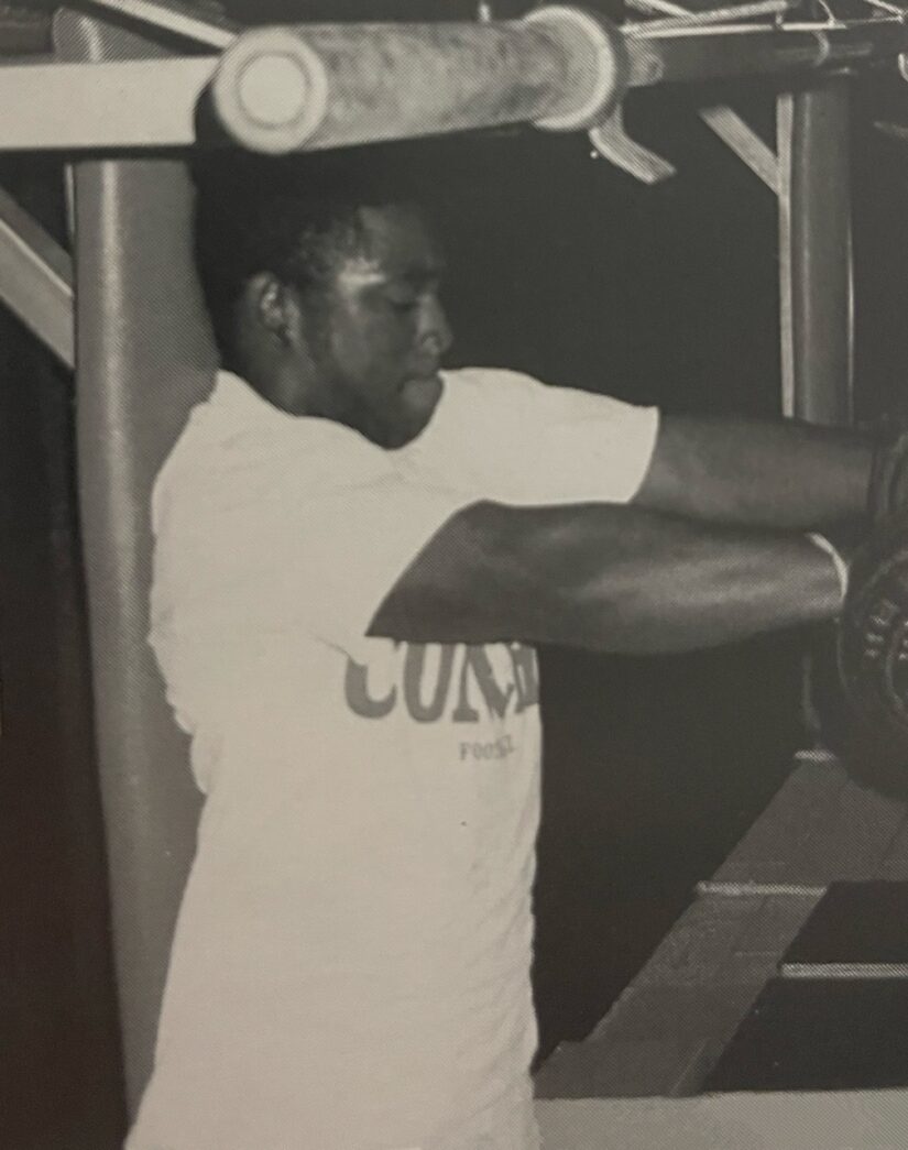 a black and white photo of a man in a gym