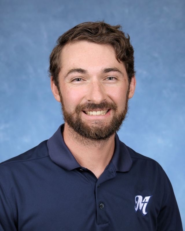 a man with a beard and a blue shirt