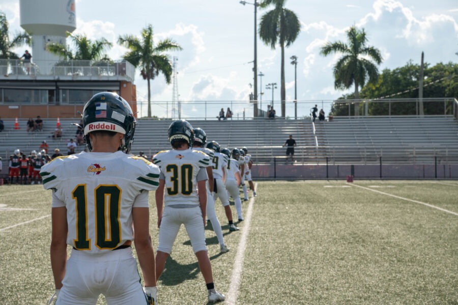 a group of football players standing on top of a field