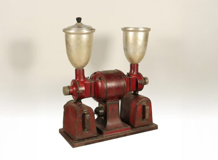 Food_02 a red and silver machine with a silver cup on top of it