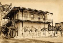 an old photo of a building with a balcony