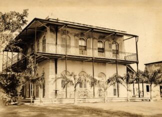 an old photo of a building with a balcony