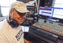a man sitting in front of a mixing desk