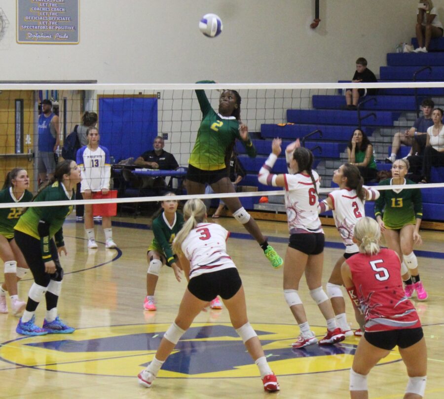 a group of young women playing a game of volleyball