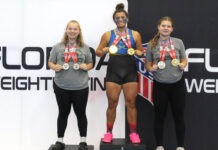 a group of women standing on top of a podium